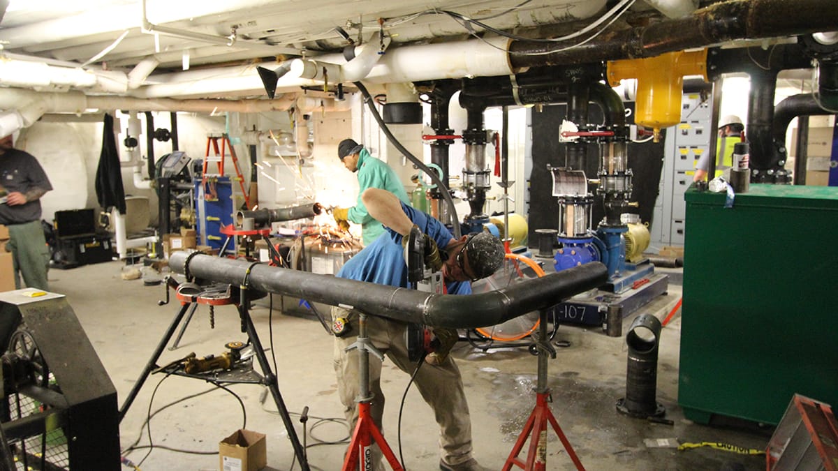 RMF Engineer inspecting steam to hot water conversion - Image 3