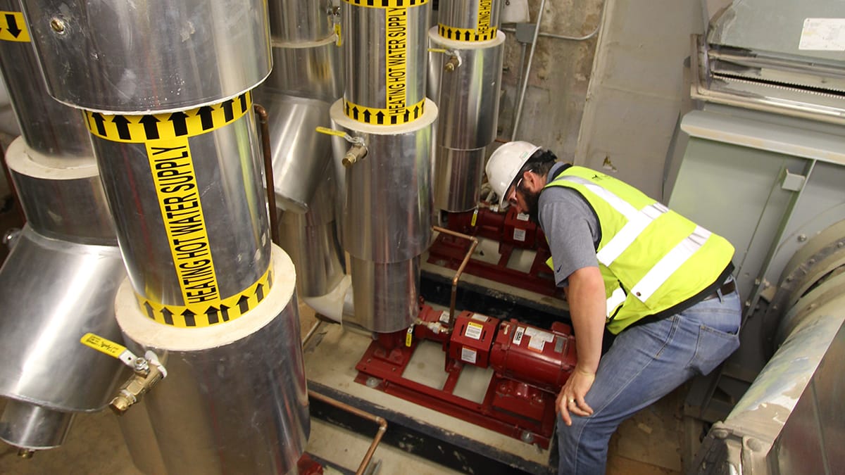 RMF Engineer inspecting steam to hot water conversion - Image 2