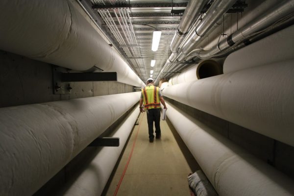 engineer walking through systems room